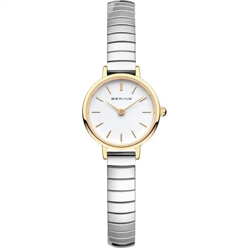 Introducing the Bering Watch - Ladies Classic Collection - 11028-914 by Bering. This elegant ladies' timepiece showcases a round white dial adorned with minimal hour markers, a gold-tone bezel with a gold PVD finish, and a slim silver and gold striped metal band. Protected by durable sapphire crystal, this watch is designed to maintain its lasting brilliance.