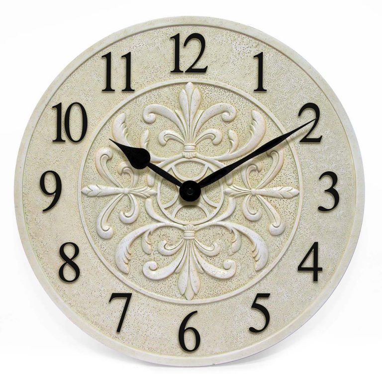 The Infinity Instruments Banc Fleur Clock (13377ST-C) is a round beige wall clock featuring black numbers, ornate floral center designs, and water resistance—ideal for stylish indoor or outdoor spaces. The clock displays 10:09.