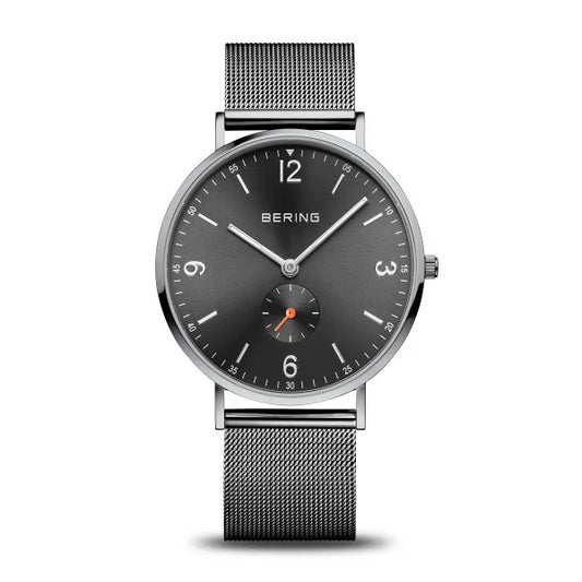 The Bering Watch - Classic Polished Grey (14040-377) for men features a black mesh band, polished grey dial, white hour markers, silver hands, and an orange-accented subdial above 6 o’clock.