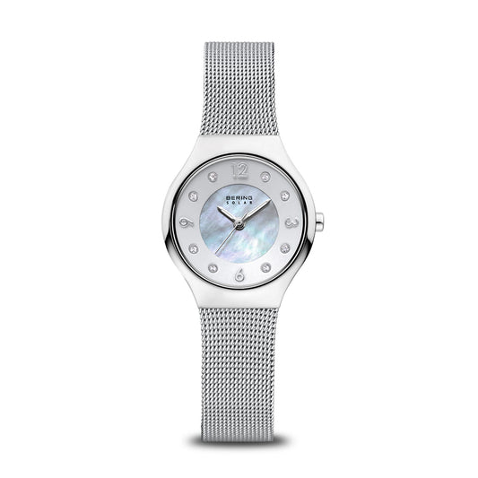 The Bering Watch - Polished Silver - 14427-004 features a silver mesh band, round iridescent mother-of-pearl dial with silver indices, crystal hour markers, minimalist design, Bering branding, and a durable sapphire crystal.