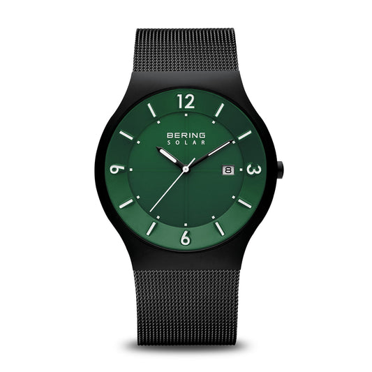 The Bering Solar Collection 14440-229 watch features a green dial, white hour markers, date at 3 o’clock, silver hands, durable sapphire crystal, and a black mesh strap.