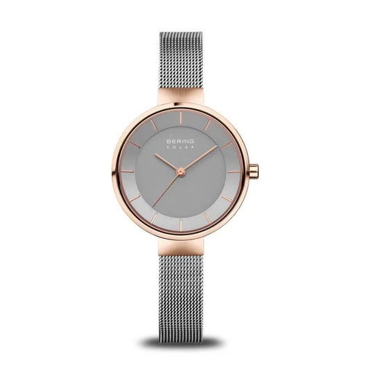 The Bering Watch - Ladies' Solar Collection - 14631-369 features a minimalist design with a gray mesh band, a rose gold stainless steel case, and a simple gray dial accented by slender hour markers and two hands. The timepiece is protected by durable sapphire crystal.
