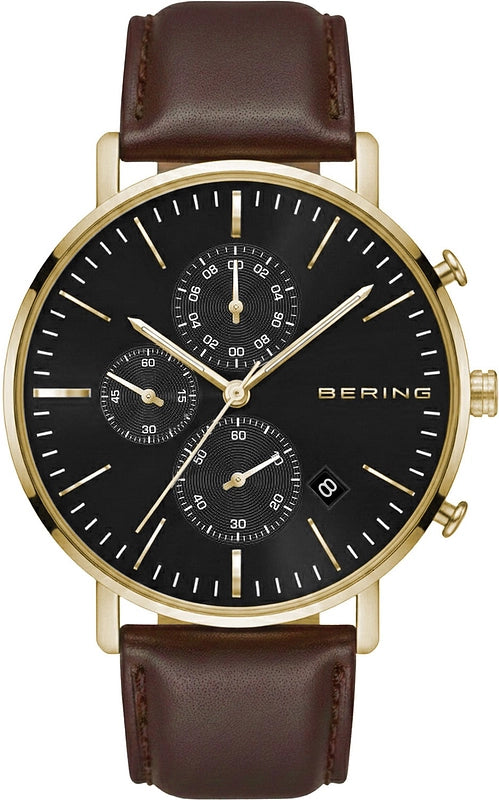 The Bering Watch - Chronograph - 14940-562 by Bering features a gold-tone case, black dial with three subdials, date display, gold hour markers and hands, and is accented with a brown leather strap for a sophisticated and elegant finish.