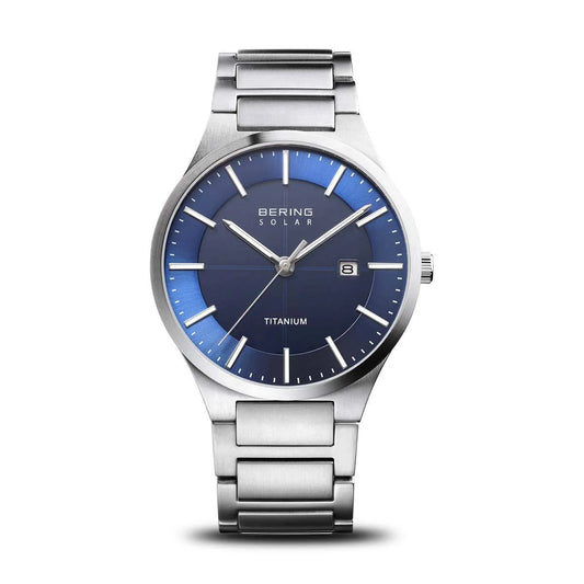 The Bering Watch - Mens Solar Collection - 15239-777 features a titanium case, blue dial, silver markers and hands, date at 3 o’clock, metal link band, and scratch-resistant sapphire crystal; shown on a white background.