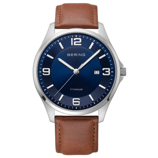 Introducing the Bering Watch - Titanium 16040-507, a men’s timepiece by Bering that showcases a bold blue dial framed by a sleek silver case. It features white hour markers, a convenient date window near the 3 o’clock position, and a classic brown leather strap. The durable sapphire crystal provides outstanding scratch resistance for reliable everyday wear.