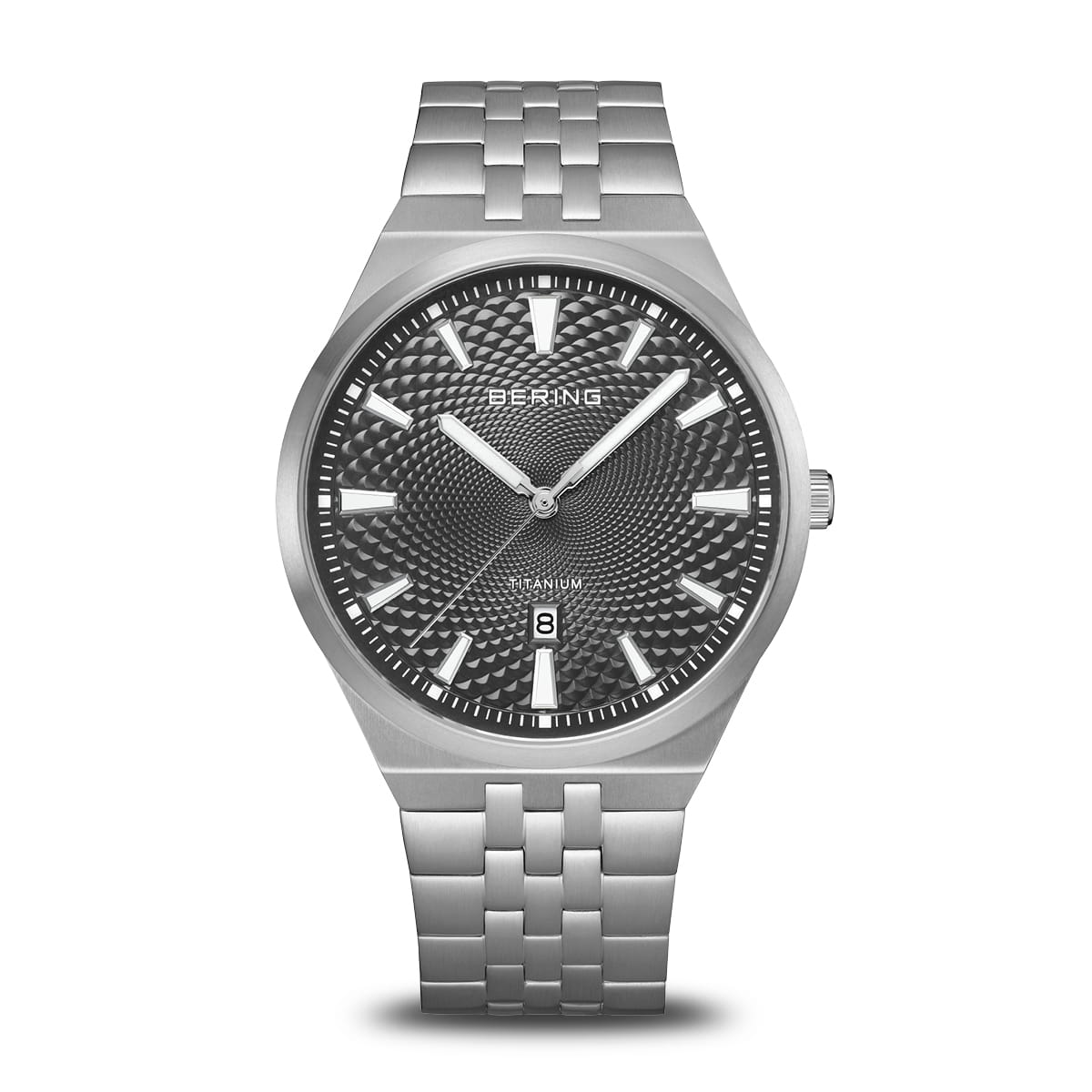 The Bering Watch - Titanium - 16141-703 features a silver case, black textured dial, silver markers and hands, sapphire crystal, date at 6 o’clock, and a metal link bracelet—highlighting Bering’s Scandinavian minimalism on a white background.