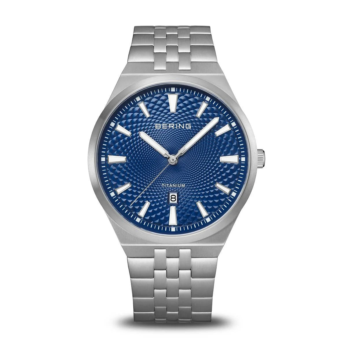 The Time Square Clock Shop Bering Watch - Titanium Collection 16141-707 features a silver titanium link band, blue textured dial with white markers, sapphire crystal, date at 6 o’clock, quartz movement, and Bering logo.