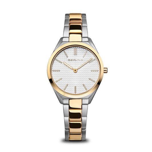 The Bering Watch - Ultra Slim Womens Two Tone (17231-704) features a silver and gold metal band, round white textured dial, gold hour markers and hands, and the Bering logo on its elegant face.