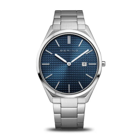 The Bering Watch - Mens Quartz Ultra Slim 17240-707 features a silver metal band, textured blue dial, silver markers and hands, date window at 3 o’clock, and the Bering logo. A refined choice for men seeking an elegant wristwatch.