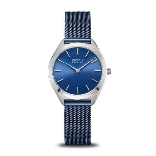 The Bering Watch - Arctic Blue Solar (17331-307) features a blue Milanese strap, blue dial, silver casing, and hands. "BERING SOLAR" is displayed below 12 o'clock, making it a refined solar ladies watch by Bering.