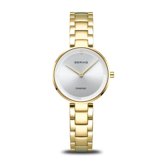The Bering Watch - Diamond - 17529-730 features a silver round face, minimalist design, single diamond at 12 o’clock, gold hour and minute hands, and an elegant gold-tone bracelet. Brand: Bering.