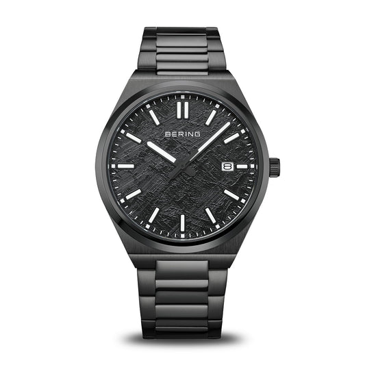 The Bering Watch - Classic Collection - 17639-722 features a textured black dial, silver markers and hands, date display at 3 o’clock, and a black stainless steel link bracelet—a sleek classic men’s watch from Bering.