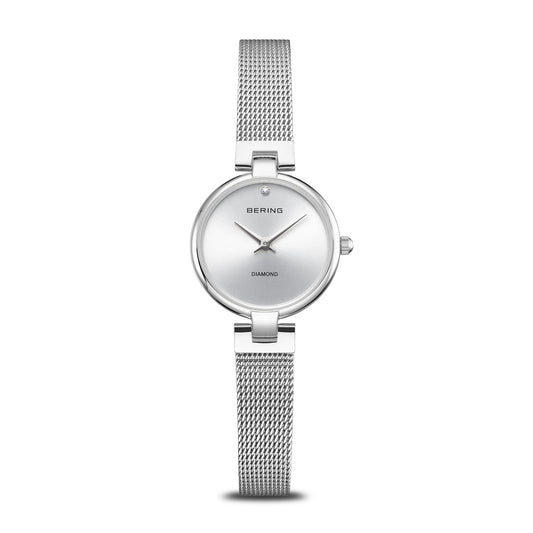 The Bering Watch - Diamond Collection - 17724-000 is a minimalist women’s watch featuring a silver mesh band, round face, simple dial with the Bering brand name, a diamond at 12 o’clock, and “Diamond” above 6 o’clock.