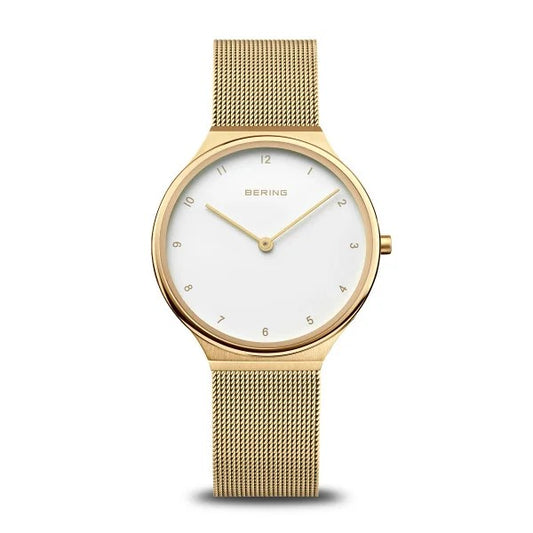 The Bering Watch - Ultra Slim Womens Gold (18434-334) features a minimalist white dial, gold hour markers, two hands, and a gold mesh band—reflecting sleek Danish design from the brand Bering.