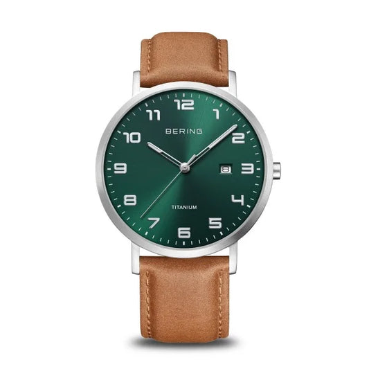 The Bering Watch - Ultra-Light Titanium Collection 18640-568 features a brown leather strap, green dial with white Arabic numerals, silver hands, date window at 3 o’clock, and a sleek silver case.