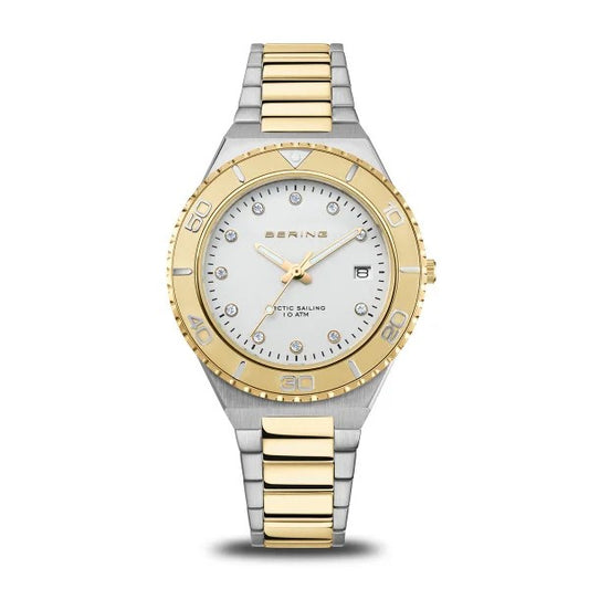 The Bering Watch - Womens Classic Collection Two-Tone (18936-710) features a silver and gold metal band, white dial, gold bezel, sapphire crystal, date display, crystal hour markers with “BERING” and “ARCTIC SAILING 10 ATM” on the face.