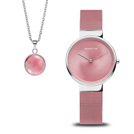 The Bering Watch Gift Set 19031-989GW features a stylish womens watch with pink Milanese strap, silver case, swirling pink dial, and a matching silver necklace with circular pendant—perfect for gifting.
