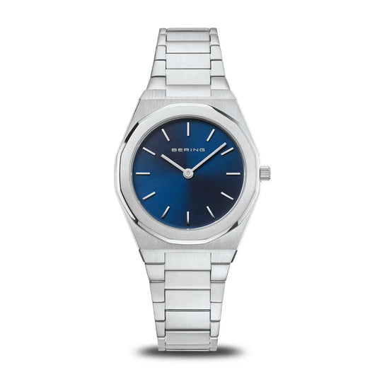The Bering Watch - Classic Womens Collection 19632-707 features a silver case, blue face, sapphire crystal, silver hour markers, and a metal link band by Bering, shown against a white background.