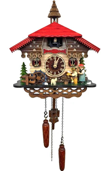 The Alexander Taron Inc. Engstler Black Forest Cuckoo Clock (45015QM) features a red roof, central clock face, lively figurines, trees, water wheel base, and two pinecone-shaped weights on chains. Made in Germany.
