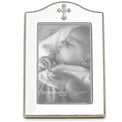 The Reed & Barton Silver Birth Frame (4746BR) elegantly showcases a black-and-white photo of a sleeping baby wrapped in a blanket, with a cross detail at the top from the Abbey Collection.