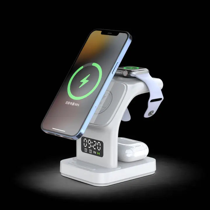 The Tech Trendz 5 in 1 Wireless Charger (1495-WH) by Tech Trendz, in white, holds a smartphone, smartwatch, and earbuds with a digital clock display on the front, all set against a black background.