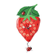 The Enesco Allen Designs Clock - Berry Sweet Clock (6018048) is a whimsical strawberry-shaped wall clock with green leaves and ladybugs, including one as a swinging pendulum at the bottom.