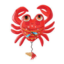 The Allen Designs Clock - Lil Crab Clock (6018634) by Enesco features a red cartoon crab with raised claws, clock hands on its body, and a swinging shell pendulum with a crab claw for a whimsical touch.