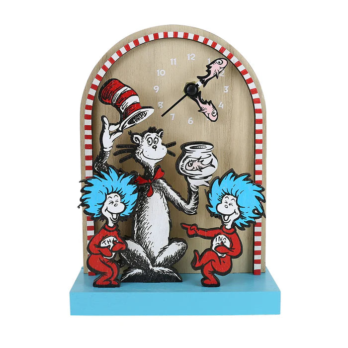 The Enesco Allen Designs Clock - Cat In The Hat Desk Clock (6019435) is a whimsical, arch-shaped desk clock featuring the Cat in the Hat holding a fishbowl, with Thing 1 and Thing 2 dancing beside him. With its playful red-striped border and vibrant Dr. Seuss-inspired design, this colorful clock brightens up any space.