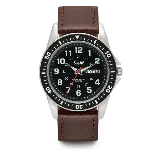 The Speidel Watch - Diver - 60332210 features a dark face, white numbers, black bezel, and brown leather strap. It displays hours, minutes, seconds, day, and date on the right, plus a classic rotating diver bezel.