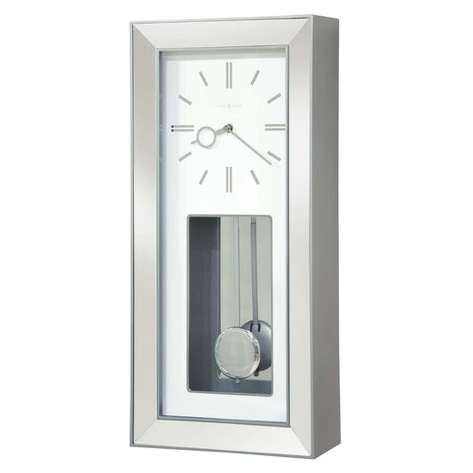 The Howard Miller Chaz Wall Clock (625-614) features a rectangular silver frame, minimalist white face, simple hour markers, silver hands, and a visible swinging pendulum behind a sleek glass-fronted case.