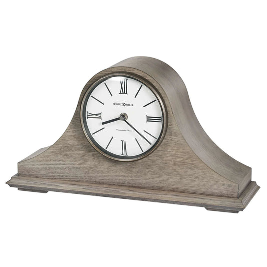 The Howard Miller Lakeside Mantel Clock (635-223) features a wooden case with a curved top, a white face, black Roman numerals, and hands—offering classic style that makes it a timeless addition to any room.