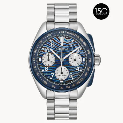 The Bulova Lunar Pilot Timascus (98A329) is a limited-edition chronograph with a blue patterned dial, three subdials, tachymeter, and stainless steel bracelet, celebrating Bulova's 150th anniversary.