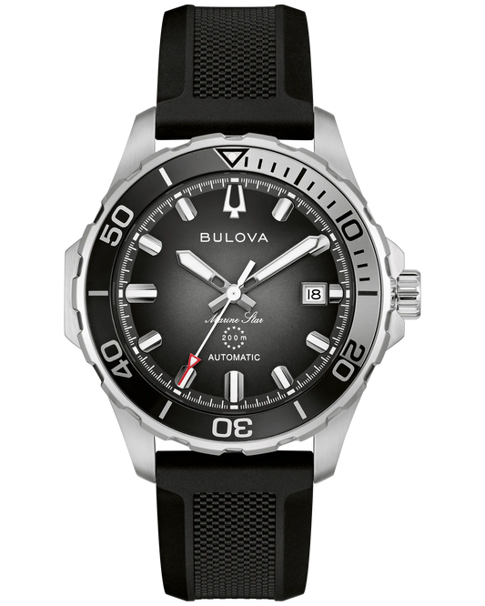 The Bulova Marine Star Series B 98B465 men’s dive watch features a black dial, silver markers, date at 3 o’clock, black rotating bezel with white numerals, and a textured black rubber strap with automatic movement.