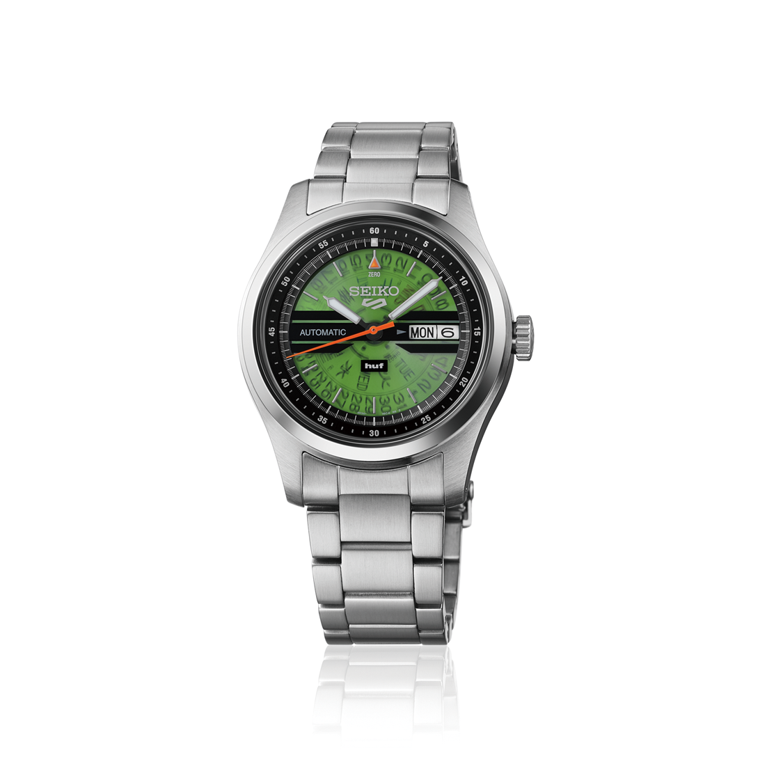 The Seiko 5 Huf Limited Edition SRMP09 wristwatch features stainless steel, a green patterned dial with black outer ring, red second hand, silver hour and minute hands, day-date display, and Time Sonar inspiration. Shown on white background.