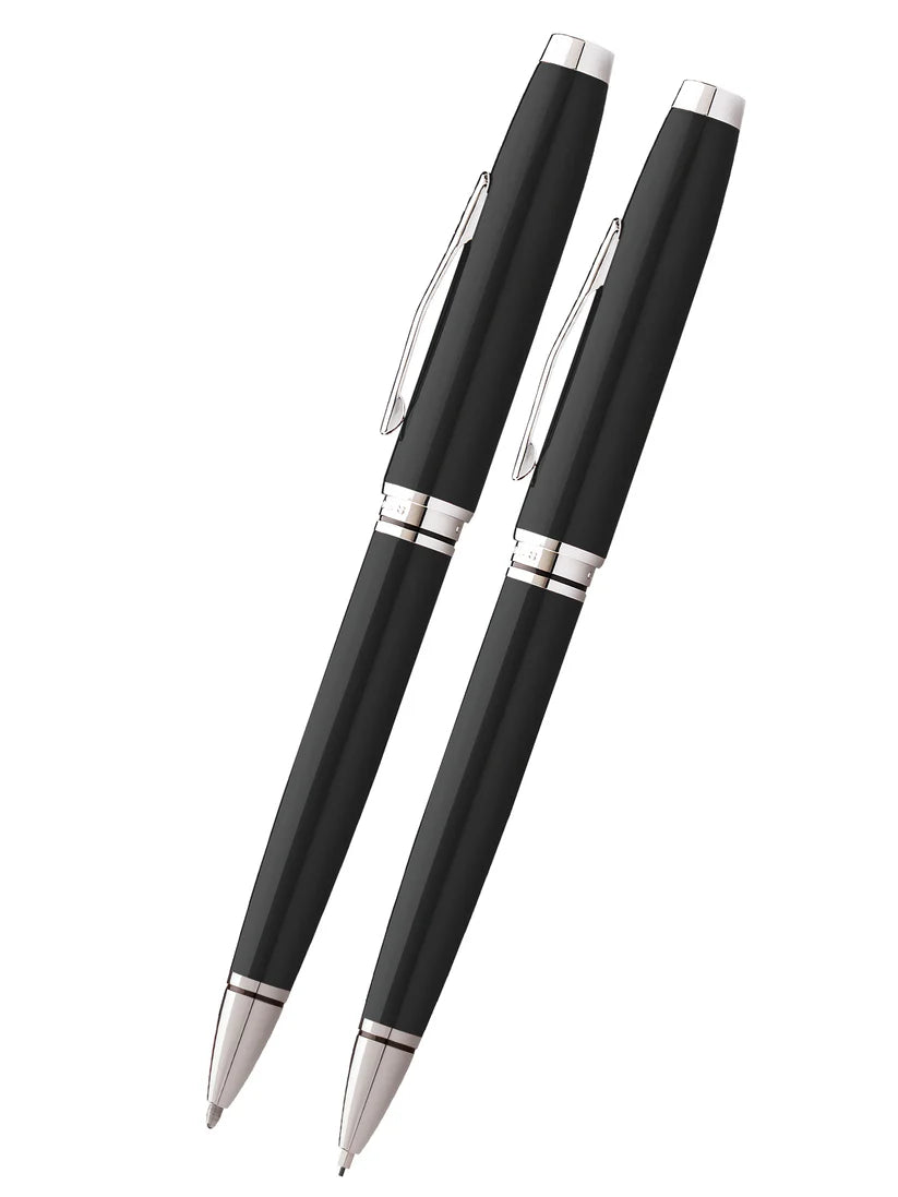 The Cross Coventry Black Pen and Pencil Set (AT0661-6) features two black lacquer writing instruments with silver accents, elegantly displayed side by side—ideal as a sophisticated gift from Cross.