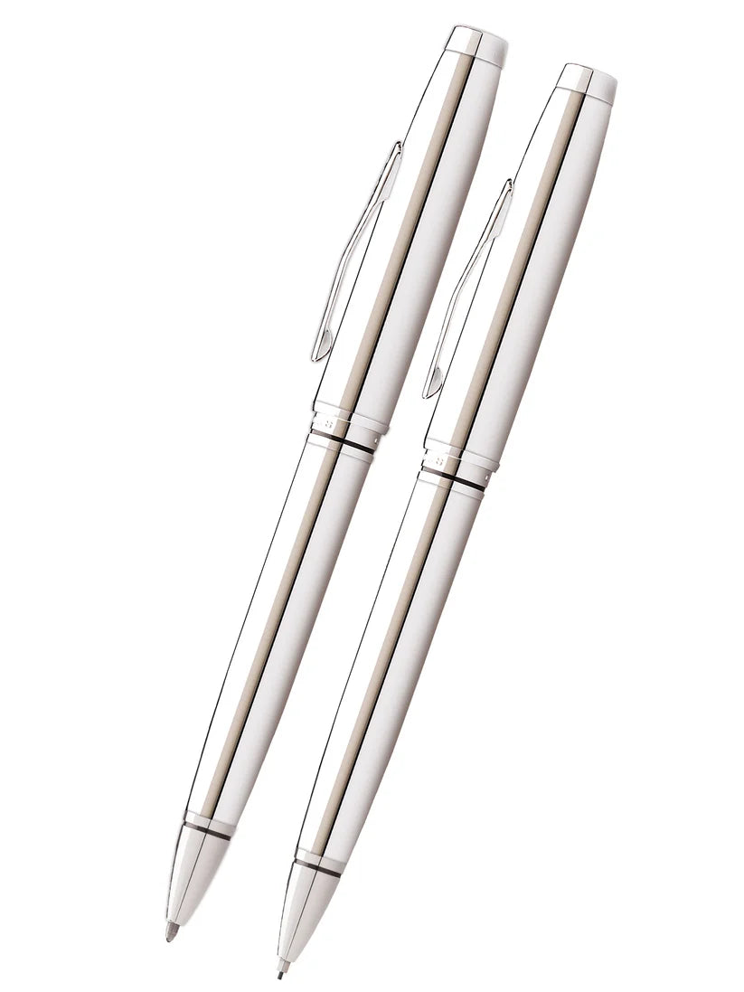 A sleek, silver Cross Coventry Polished Chrome Pen and Pencil Set (AT0661-7) are placed diagonally side by side on a white background.