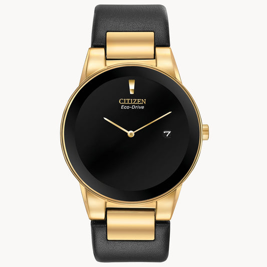 The Citizen Axiom AU1062-05E men’s watch features a black leather strap, gold-tone case, minimalist black dial with gold hands, and a date window at 3 o’clock.