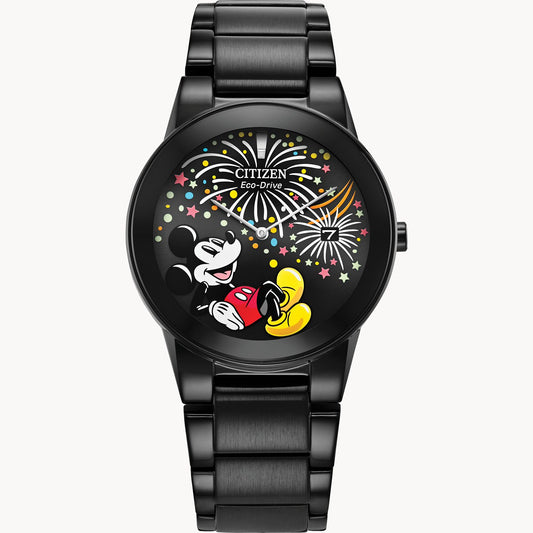 The Citizen Watch - Mickey Fiesta (AU1095-57W) is a unisex Eco-Drive timepiece featuring a smiling Mickey Mouse with fireworks and stars on a black dial, paired with a sleek metallic black band.