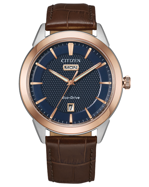The Citizen Watch - Rolan Eco-Drive AW0096-06L features a blue textured dial, rose-gold bezel, brown leather strap, silver case, day display at 12 o’clock and date at 6 for timeless style.