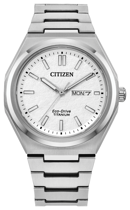 The Citizen Zenshin Three-Hand (AW0130-85A) features a Super Titanium case, light textured dial, silver markers and hands, day-date at 3 o’clock, metal link bracelet, and Eco-Drive technology. Time shown is 10:08:36.