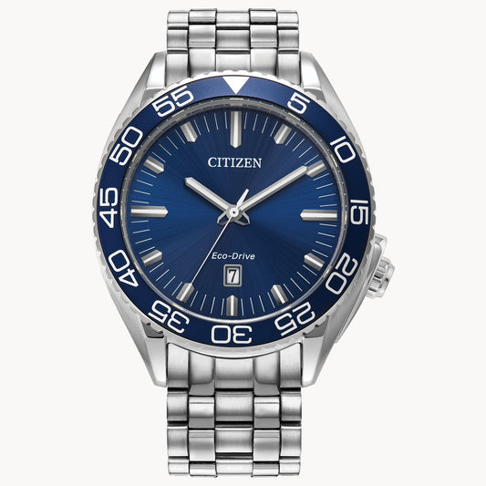 The Citizen Carson AW1770-53L men's watch features a blue dial, silver hour markers, date at 3 o’clock, and a stainless steel band and bezel with bold white minute numerals.