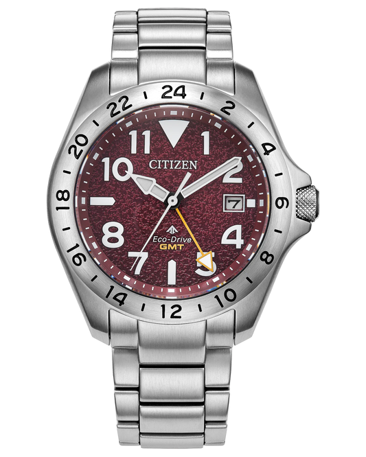 The Citizen Promaster Land BJ7150-50W features a stainless steel band and case, maroon textured dial with white numerals, date window at 3 o'clock, and four hands including a yellow GMT hand.