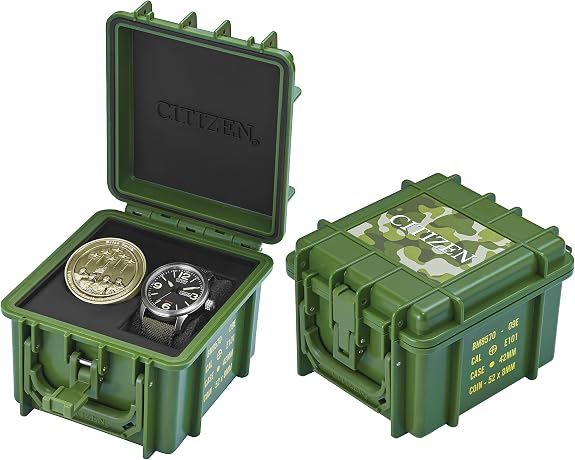 Two green, military-style cases—one open to display the Citizen Watch - Military Commemorative Box Set - BM8570-09E and a coin, the other closed with camouflage and bold Citizen branding on its lid.