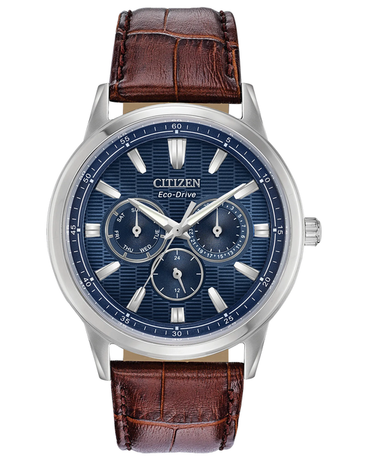 The Citizen Corso Eco-Drive BU2070-12L men's watch features a blue dial, silver markers, three subdials, and a brown crocodile-pattern leather strap.