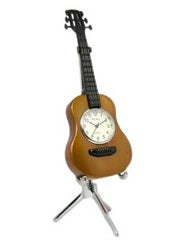 The Sanis Enterprises Mini Clock - Guitar Acoustic Brown (C254BR) features a clock face in the guitar’s body and stands upright on a sleek silver tripod stand.