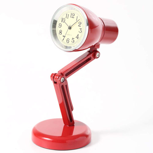 The Tokyobay Mini Clock - Lamp Red (C3216-RD) features an adjustable alloy arm and a round white face with black numbers and hands, replacing the bulb to create a unique red desk lamp by Tokyobay.