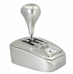 The Sanis Enterprises Sanis Mini Clock – Manual Gear Shifter (Model C3286) is a silver desktop timepiece styled like a gear shifter, with visible gear positions and an analog clock inset on the side.