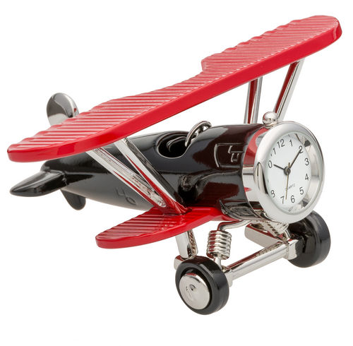 Introducing the Sanis Mini Clock - Red & Black Plane (C3569RDBK) by Sanis Enterprises. This charming collectible features a detailed miniature model of a vintage red and black plane, complete with bright red wings and a mini clock set in the nose. Capturing nostalgic aviation style, it’s a perfect piece for keeping you on time and adding character to any collection.