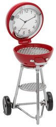 Introducing the Sanis Mini Clock - Red Grill (C3637RD) by Sanis Enterprises—a whimsical mini clock crafted to resemble a classic red grill, featuring a clock face nestled in the open lid, realistic metal grates, a lower shelf, and two black wheels at the base. Perfect for collectors of Sanis Enterprises creations and barbecue fans alike.
