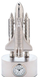 A sleek Sanis Enterprises Mini Clock - Silver Rocket (C366SIL), featuring two boosters, stands proudly on a round base and showcases its distinguished clock face on the front.